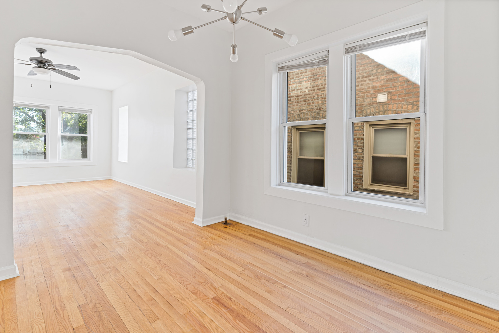 10342 South Calumet Avenue, Unit 2 Chicago, IL 60628 - Photo 18 of 25 a view of an empty room with wooden floor and a window