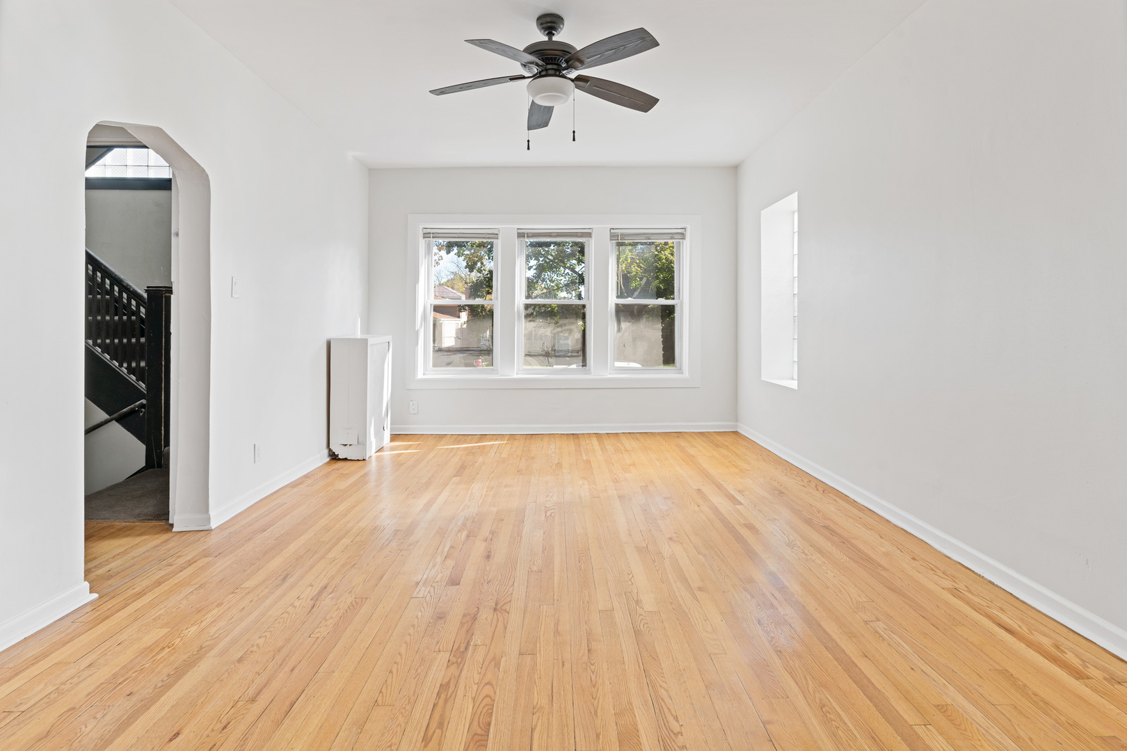 10342 South Calumet Avenue, Unit 2 Chicago, IL 60628 - Photo 22 of 25 a view of empty room with wooden floor and fan