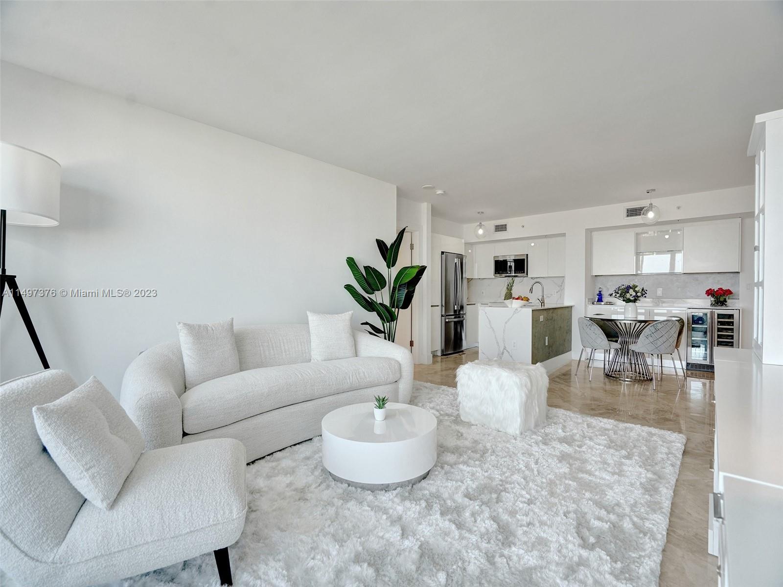 90 Alton Road, Unit 1109 Miami Beach, FL 33139 - Photo 11 of 23 a living room with furniture and kitchen view