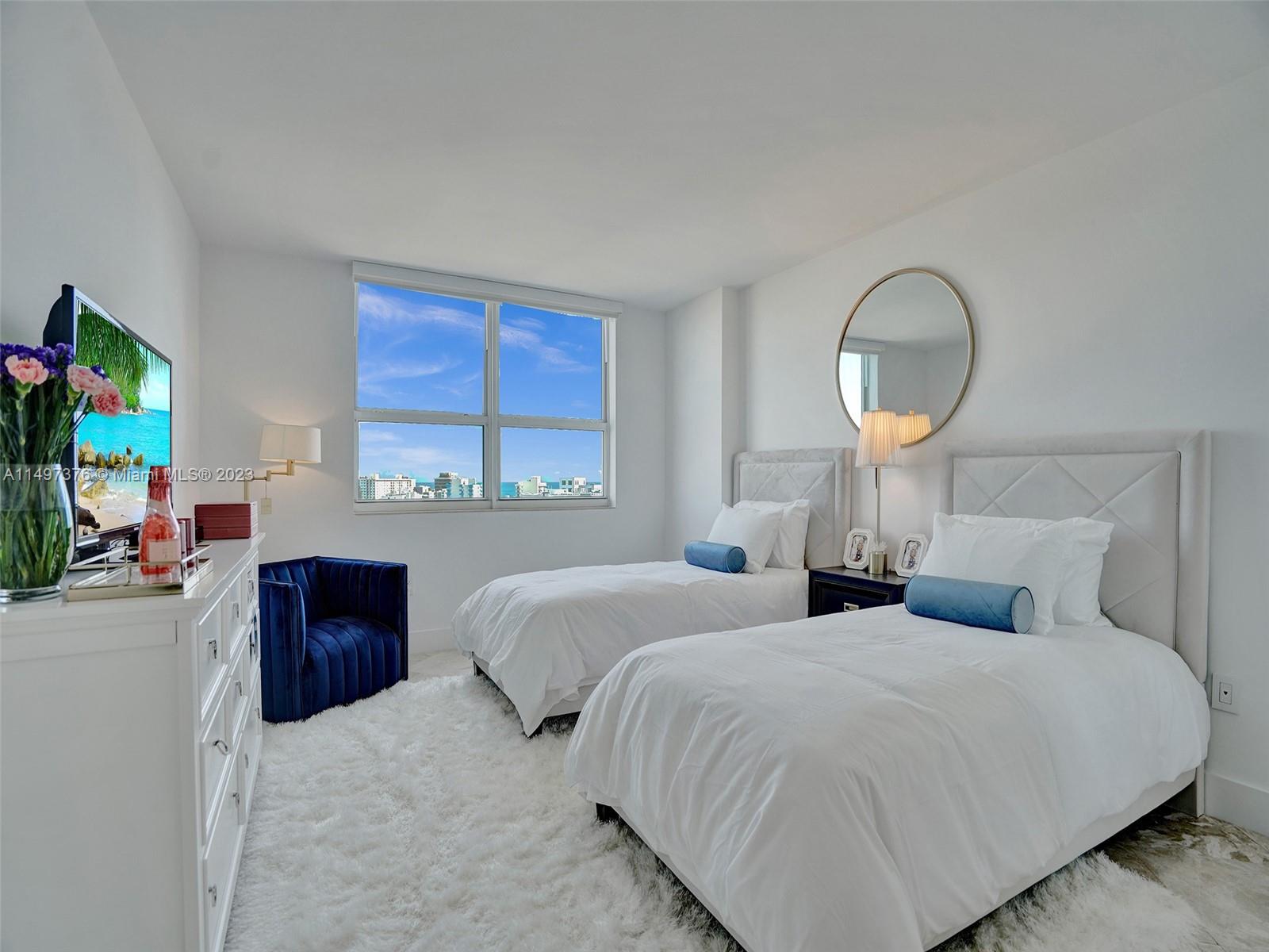 90 Alton Road, Unit 1109 Miami Beach, FL 33139 - Photo 4 of 23 a bedroom with bed and a flat screen tv
