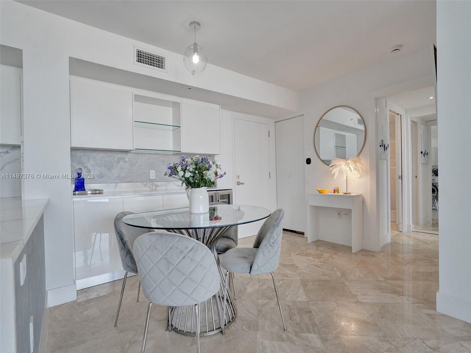 90 Alton Road, Unit 1109 Miami Beach, FL 33139 - Photo 7 of 23 a dining room with furniture and window