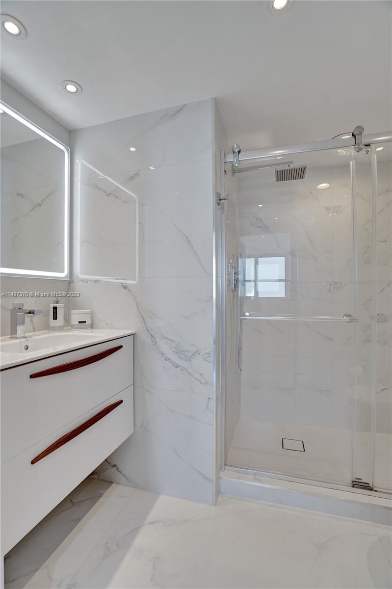 90 Alton Road, Unit 1109 Miami Beach, FL 33139 - Photo 9 of 23 a bathroom with a sink double vanity and a mirror