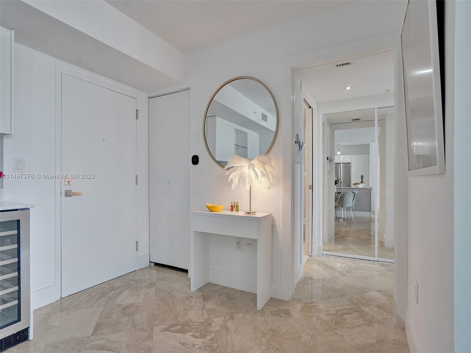 90 Alton Road, Unit 1109 Miami Beach, FL 33139 - Photo 10 of 23 an empty room with mirror and a bathroom