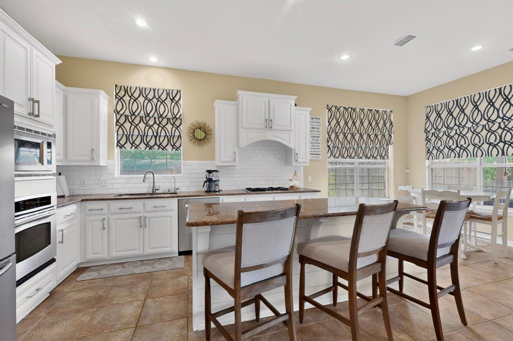4004 White Porch Road Plano, TX 75024 - Photo 13 of 40 a kitchen with a table chairs sink and cabinets