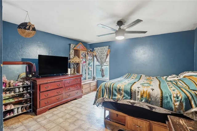 a bedroom with furniture and a flat screen tv