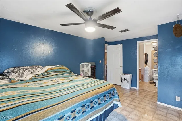 a bedroom with a bed and a lamp