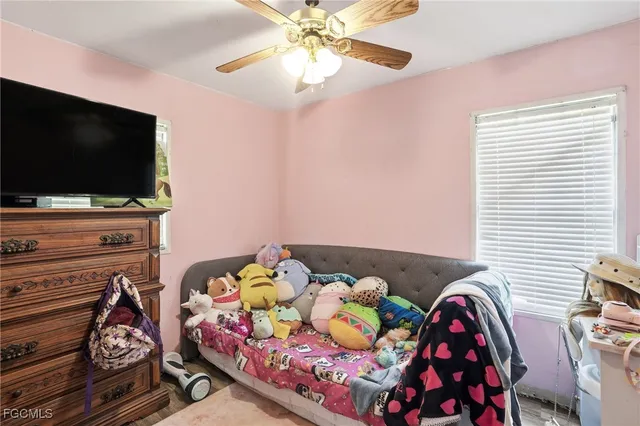a bedroom with furniture and a flat screen tv