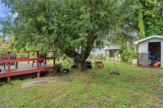 a view of a wooden deck and a backyard