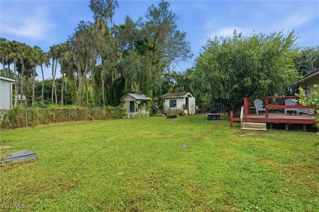 a view of a house with backyard and sitting area