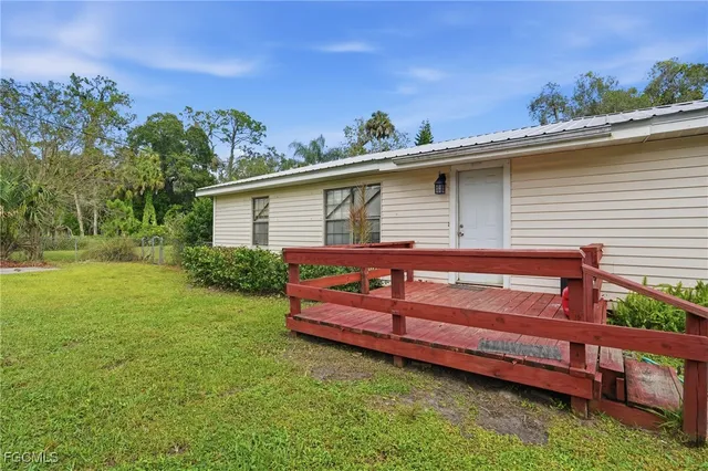 a view of a backyard with sitting area