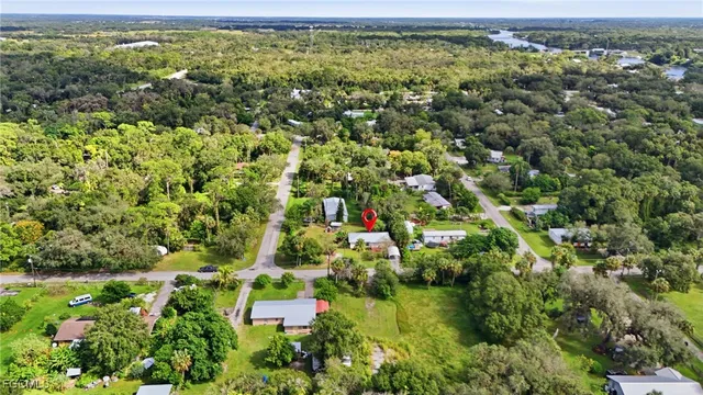 an aerial view of residential houses with outdoor space and trees