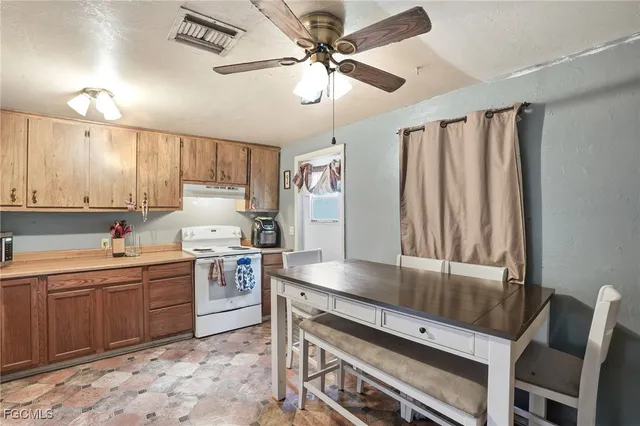 a kitchen with a stove a sink and cabinets