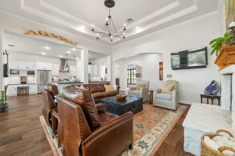 a kitchen with kitchen island wooden floors and stainless steel appliances