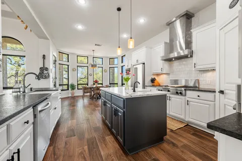 a kitchen with sink stove and cabinets