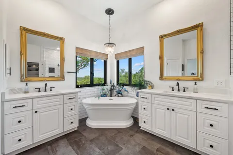 a view of a hallway with bathroom and mirror
