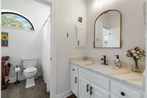 a bedroom with a bed dresser and a window