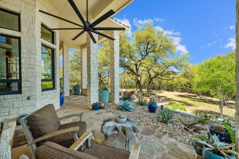 a view of a patio with table and chairs and potted plants