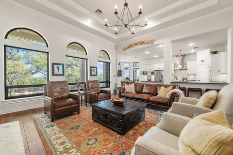 a living room with fireplace furniture and a large window