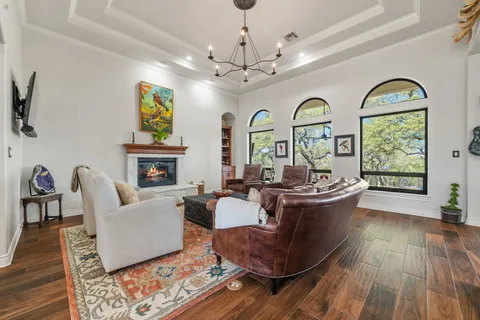 a living room with fireplace furniture and a wooden floor