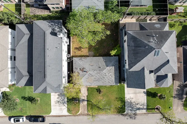 an aerial view of a house with garden space and street view