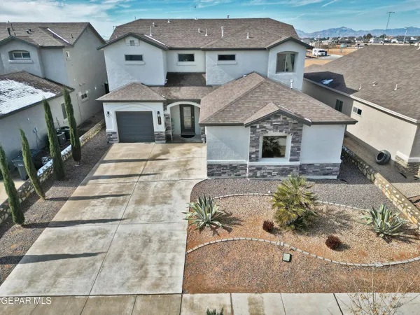 an aerial view of a house with yard