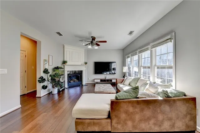 a living room with furniture fireplace and flat screen tv
