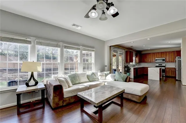 a living room with furniture and wooden floor