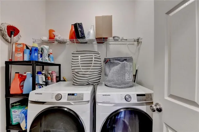 a utility room with dryer washer and shoe rack