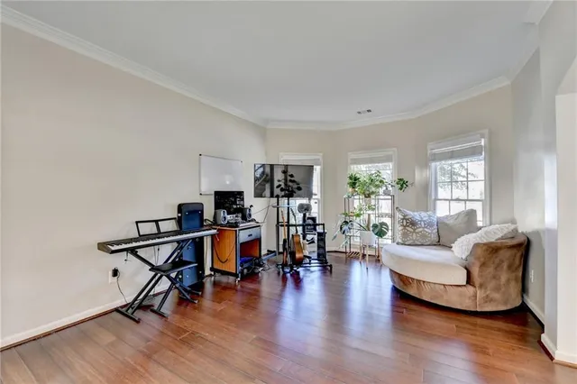 a living room with furniture and wooden floor