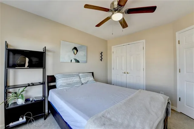 a bedroom with a bed and a flat tv screen on dresser