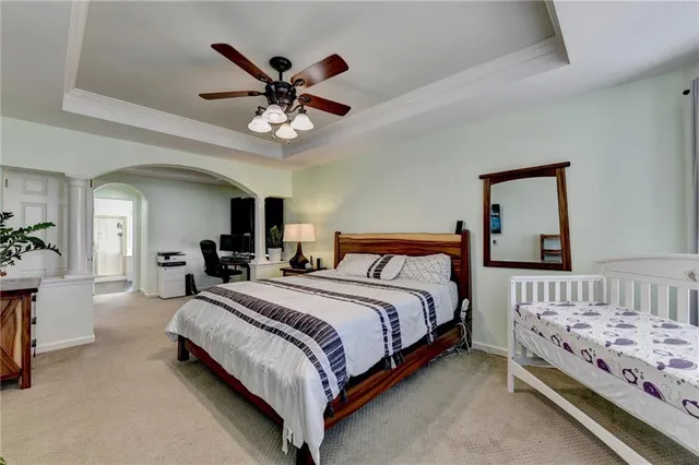 a bedroom with a bed and a chandelier