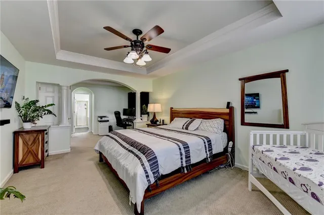 a bedroom with a bed and a chandelier