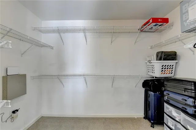 a view of a storage and utility room with washer and dryer