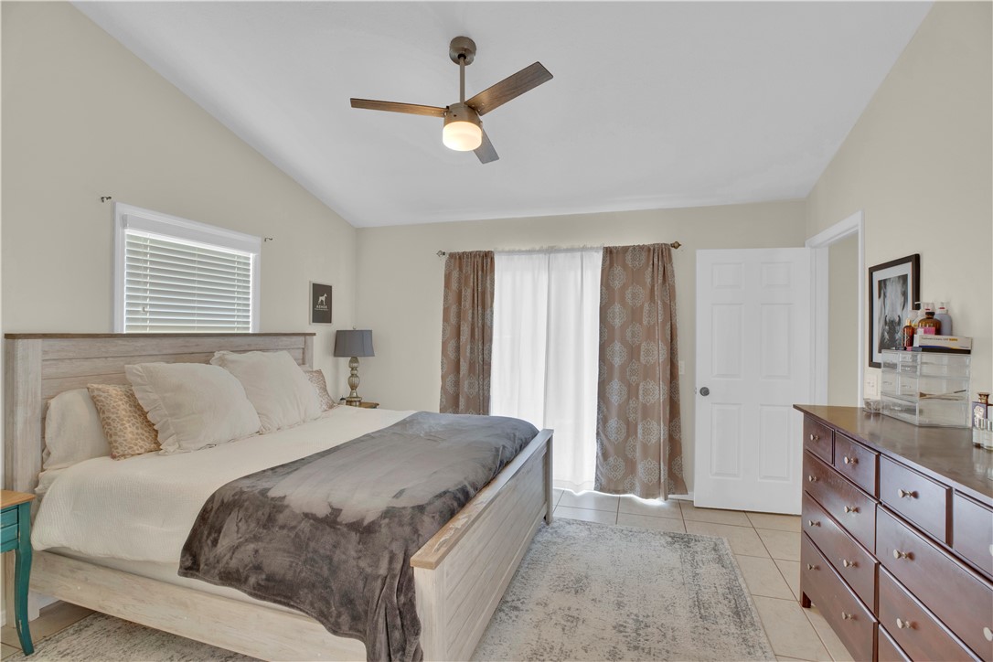 726 63rd Avenue Vero Beach, FL 32968 - Photo 14 of 22 a spacious bedroom with a large bed and a chandelier