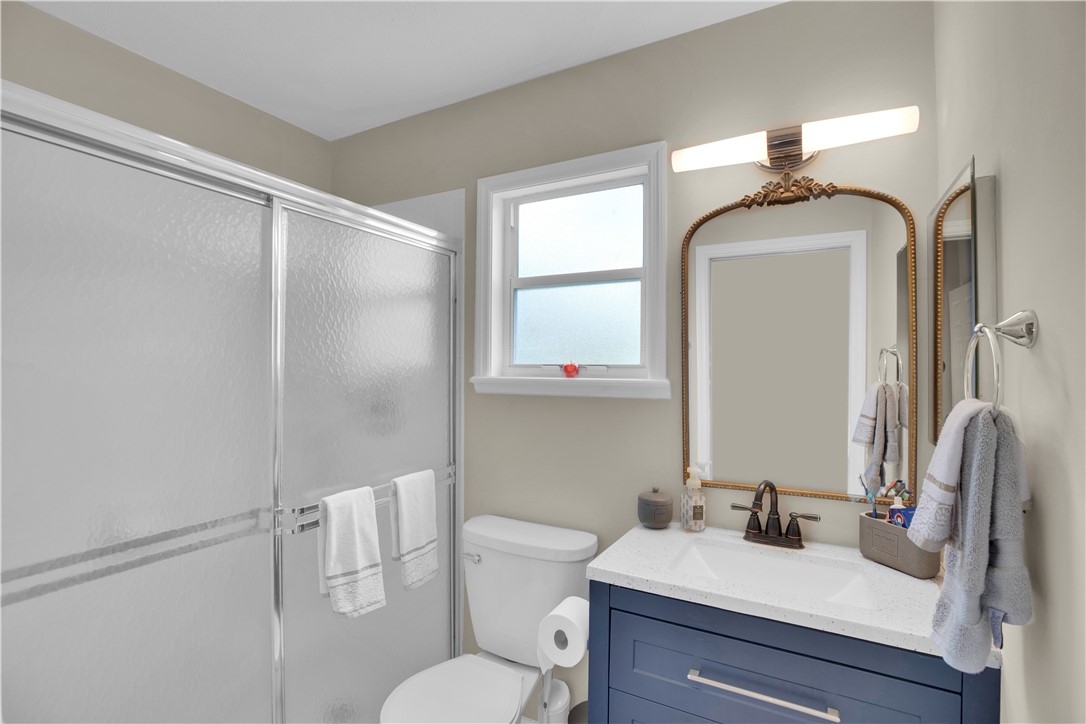 726 63rd Avenue Vero Beach, FL 32968 - Photo 15 of 22 a bathroom with a granite countertop sink mirror vanity and toilet