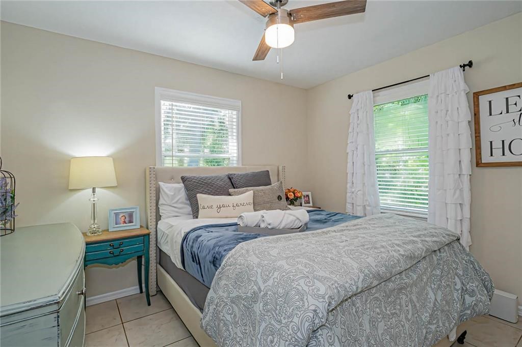 726 63rd Avenue Vero Beach, FL 32968 - Photo 16 of 22 a bedroom with a bed and a chandelier