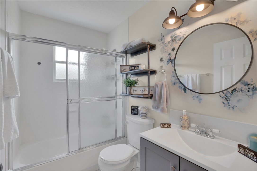 726 63rd Avenue Vero Beach, FL 32968 - Photo 18 of 22 a bathroom with a sink a toilet and a mirror