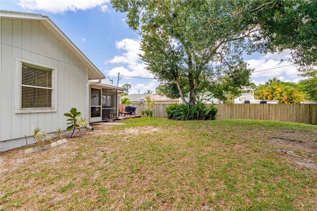 726 63rd Avenue Vero Beach, FL 32968 - Photo 21 of 22 a view of a house with backyard and a tree