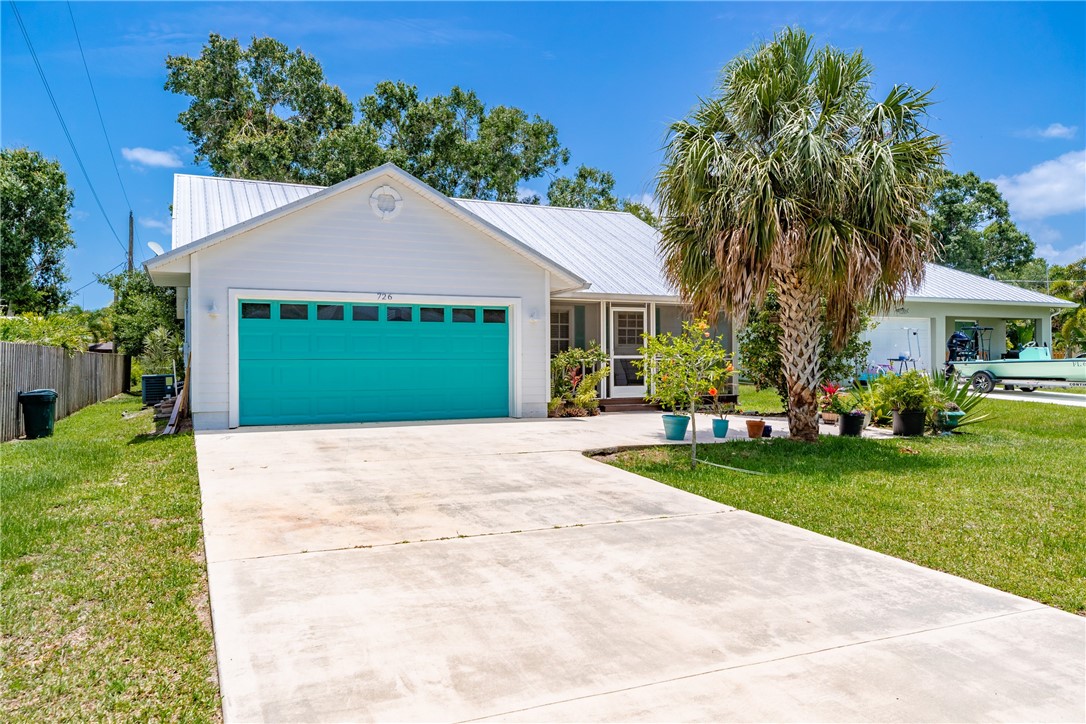 726 63rd Avenue Vero Beach, FL 32968 - Photo 3 of 22 a view of a house with a yard and potted plants