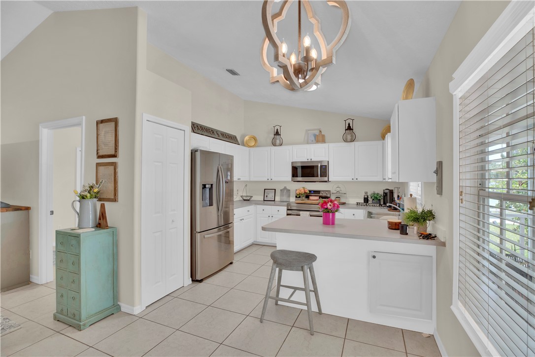 726 63rd Avenue Vero Beach, FL 32968 - Photo 6 of 22 a kitchen with stainless steel appliances a refrigerator and microwave