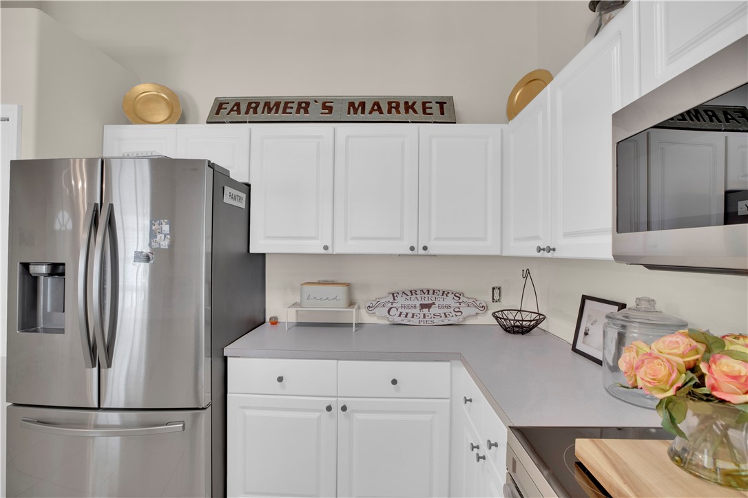 726 63rd Avenue Vero Beach, FL 32968 - Photo 8 of 22 a kitchen with a refrigerator and cabinets