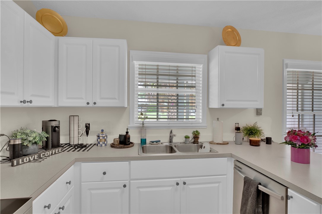 726 63rd Avenue Vero Beach, FL 32968 - Photo 9 of 22 a kitchen with white cabinets and sink