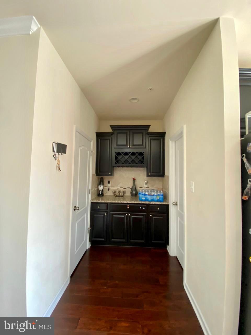 7014 Foxton Way Hanover, MD 21076 - Photo 18 of 29 Elegant hallway with dark cabinetry.