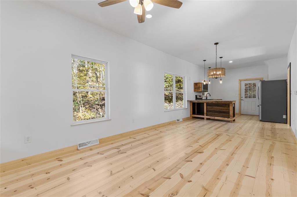 723 Glenfield Road Sewickley, PA 15143 - Photo 23 of 45 a view of an empty room with a window and a kitchen
