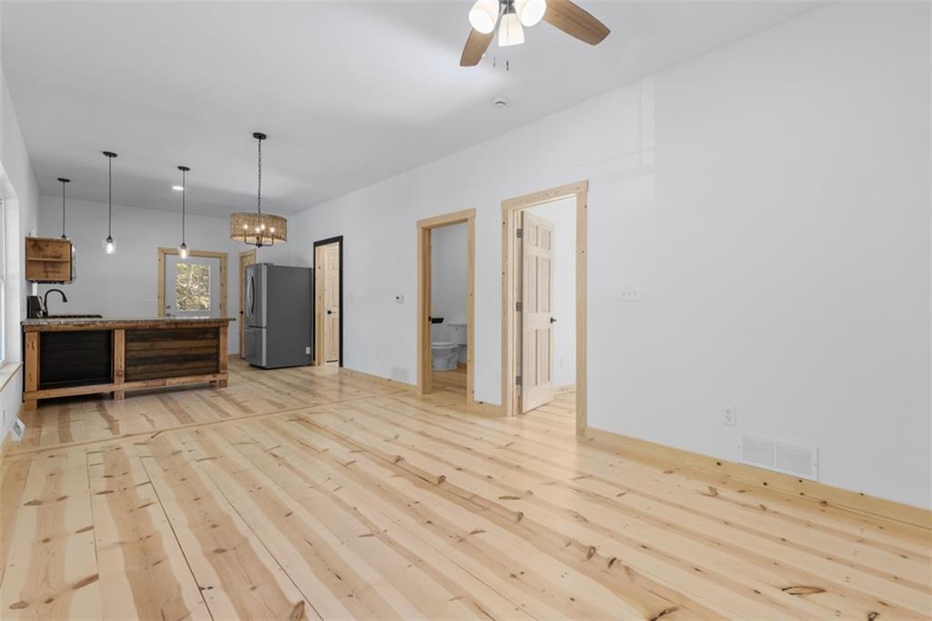 723 Glenfield Road Sewickley, PA 15143 - Photo 24 of 45 a view of empty room with wooden floor and kitchen