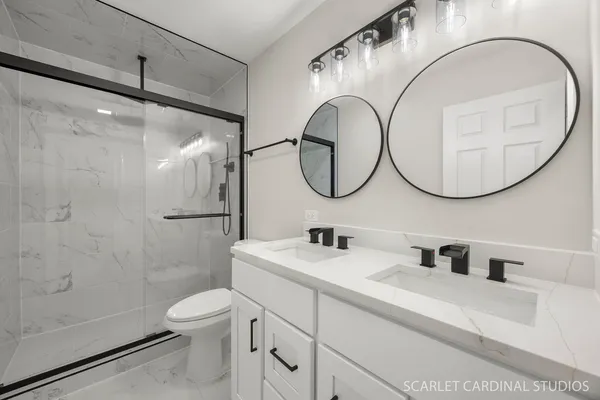 a bathroom with a sink a toilet and a mirror