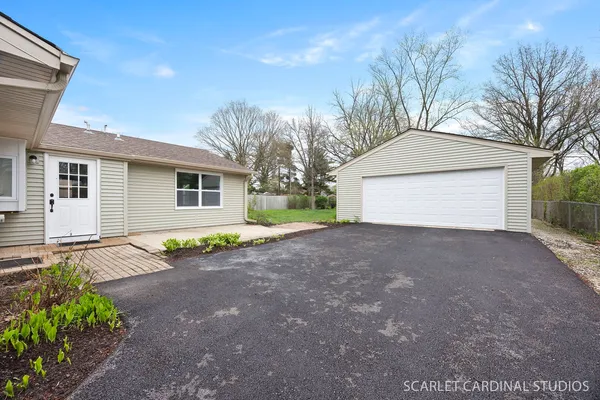 a view of a house with a yard and garage