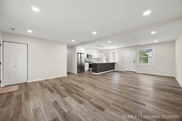 a view of kitchen and hall with wooden floor