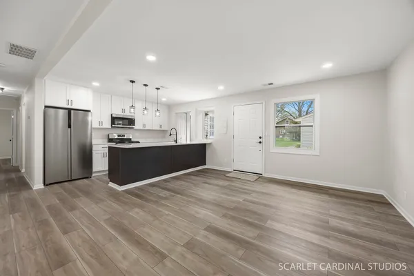 a view of kitchen with wooden floor