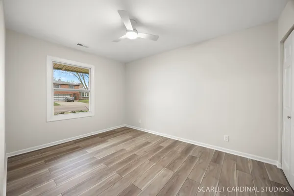 wooden floor in an empty room with a window